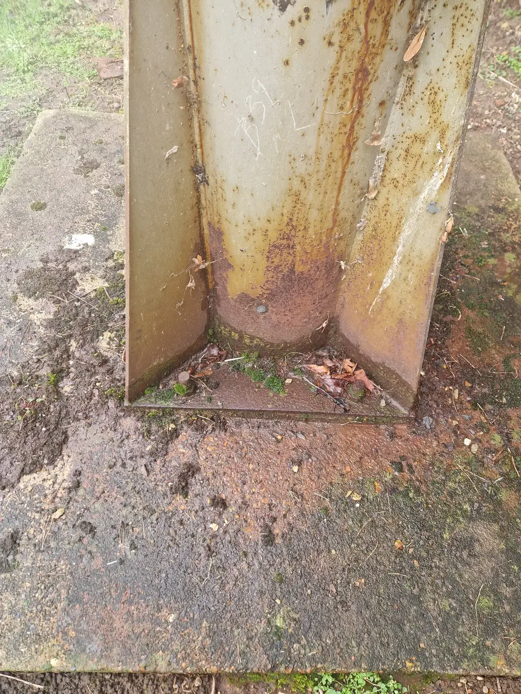 Close-up of a leaking joint on a stainless flue with brown and yellow condensate staining down the seam