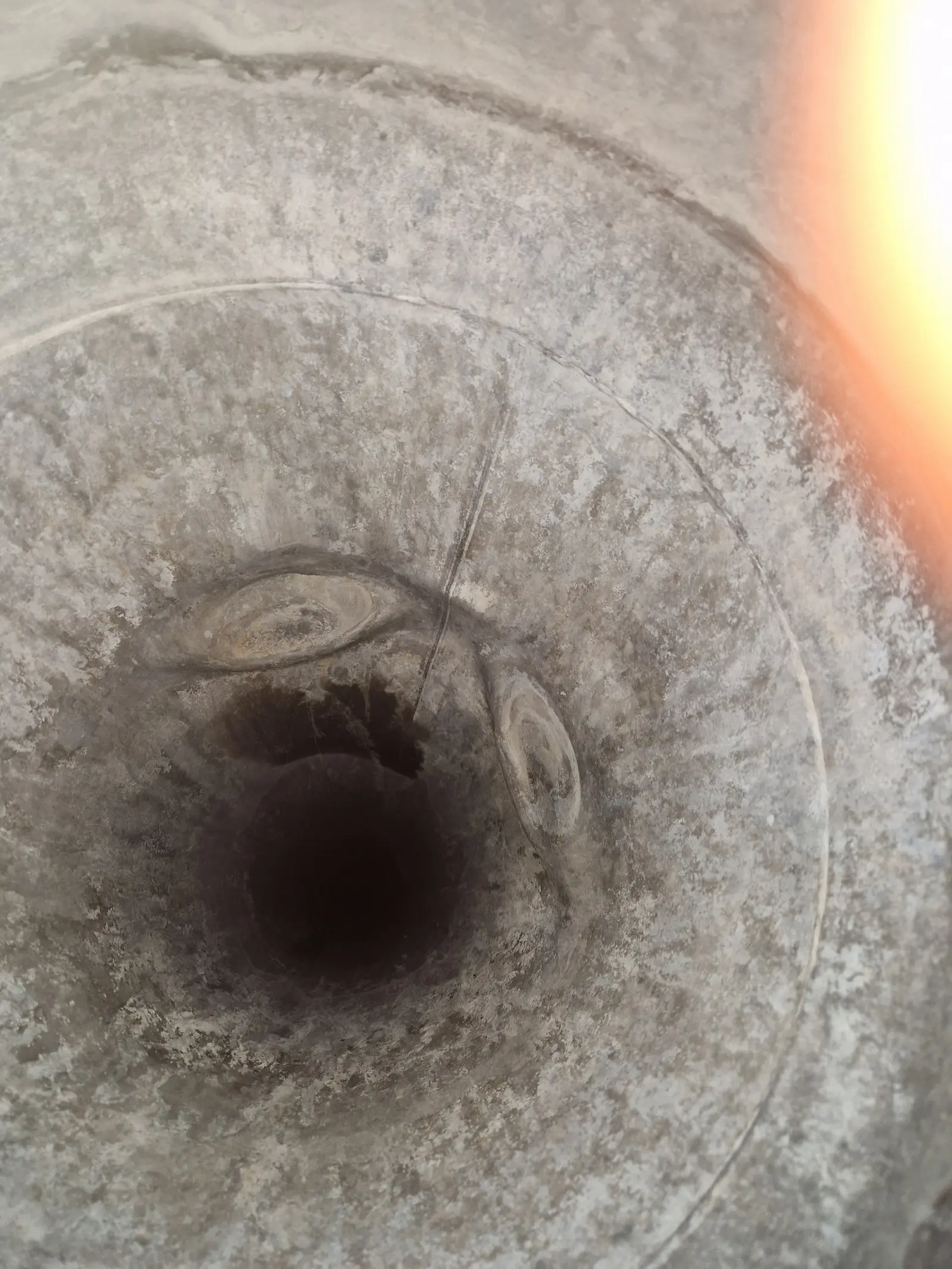 Looking down into the top of a twin wall flue where the corroded inner liner has dropped below the outer casing