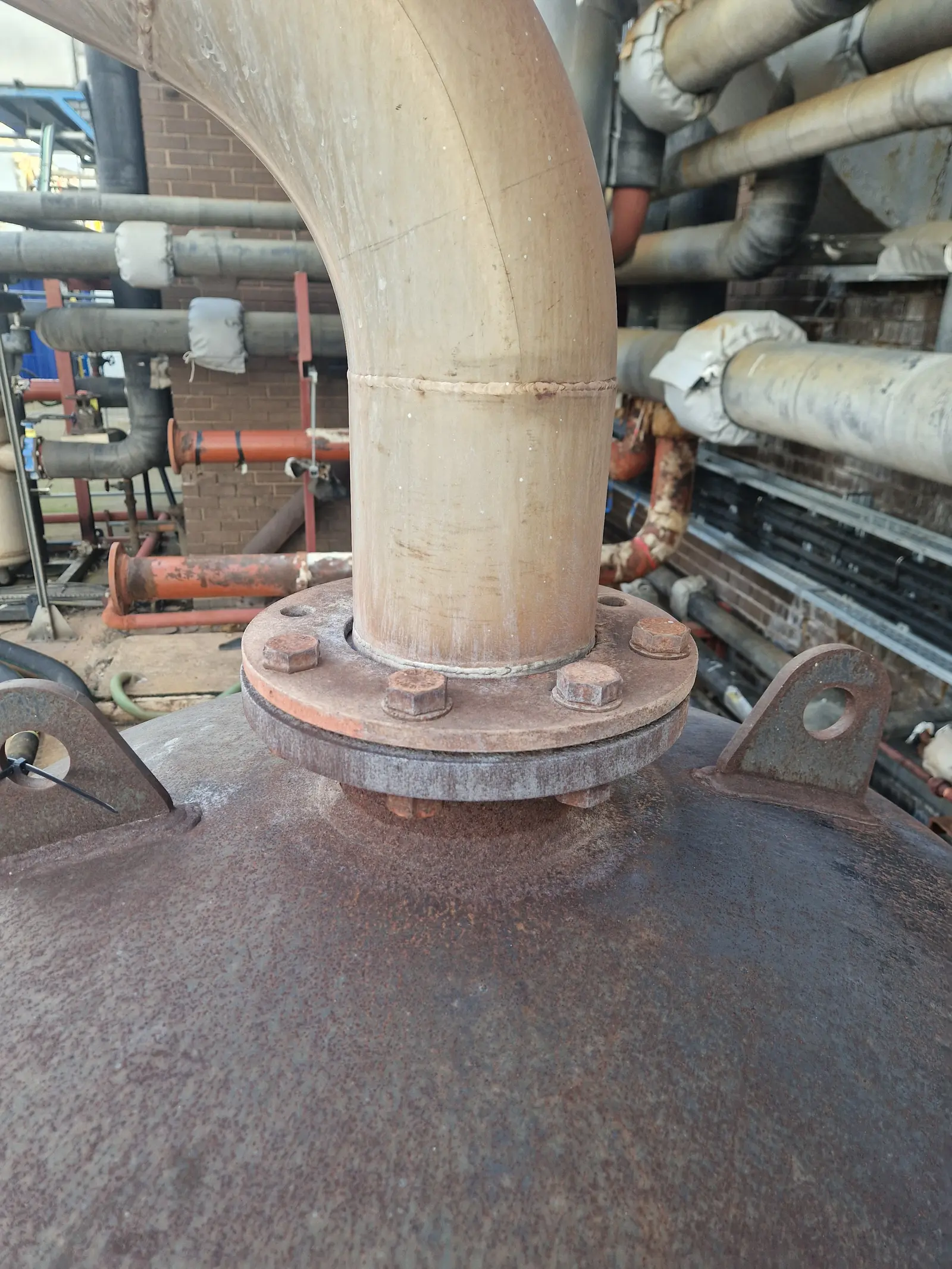 Water staining on the boards around the base of a flue where it passes through a riser floor